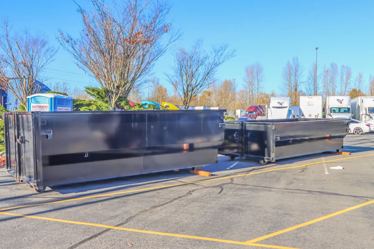 Professional dumpster rental service with roll-off container on residential driveway in Belton